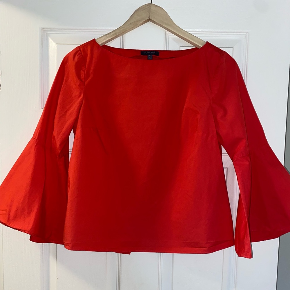 Red long sleeve shirt. Open split back